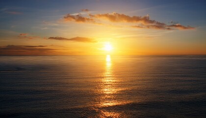 Fototapeta premium The Beautiful Golden Sunset Over The Calm Ocean Horizon With Sun Reflection On Water Surface Background