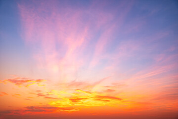 Fototapeta premium Sky sunset,Beautiful sunrise sky with vibrant gradient orange and gold colors and soft blue, Clear atmosphere with wispy clouds. Peaceful, perfect for background and copy space, High resolution images