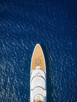 Aerial overhead view of a bow of a modern luxury yacht with wooden teak deck with copy space