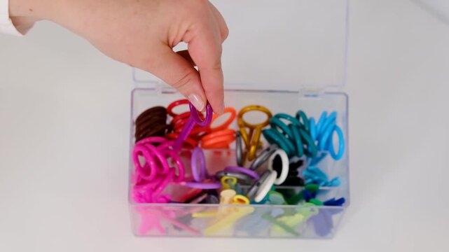 Colorful orthodontic elastics and ligatures arranged on table for dental treatment and braces care