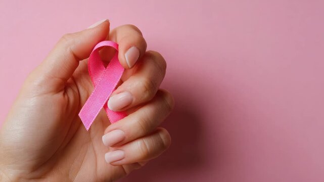 female hand hold pink ribbon breast cancer health care concept animation