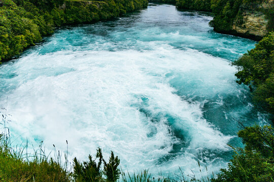 Powerful Turquoise River Rapids Between Forest Cliffs