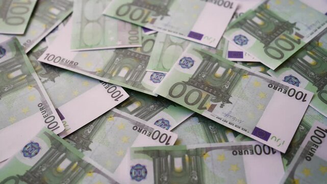 Background of one hundred euro banknotes scattered randomly.