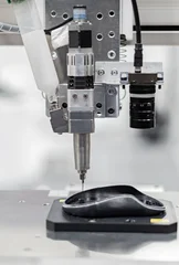 Automatic glue dispensing machine Robot holding glue syringe Injection. Robot Welding © Photo Gallery