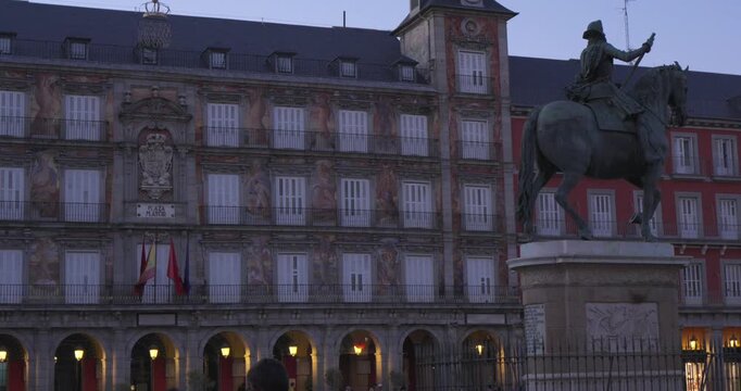 Madrid, Spain, July 4, 2026: Pan across the historic Plaza Mayor facade ending at the equestrian statue of Philip III. Evening view of one of Madrid&rsquo;s iconic landmarks.
