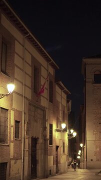 Madrid, Spain, July 4, 2026: Night view of Casa de la Villa illuminated by traditional street lamps in Madrid&rsquo;s historic center. The historic civic building stands beside a narrow street under a clear