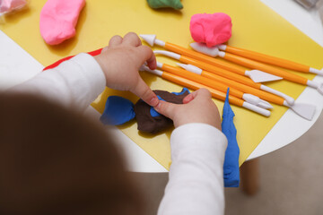 Little baby plays with plasticine. Children's creativity. Motor skills development. © splitov27