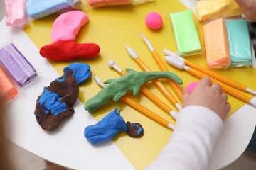 Little baby plays with plasticine. Children's creativity. Motor skills development. © splitov27