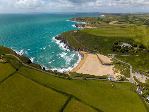 Aerial panoramic landscape view from the sea of Poldhu Cove and surfing beach on the Lizard peninsula in Cornwall, UK