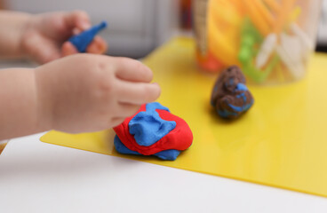 Little baby plays with plasticine. Children's creativity. Motor skills development. © splitov27