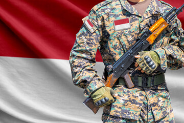 Fototapeta premium Indonesia flag with soldier holding assault rifle