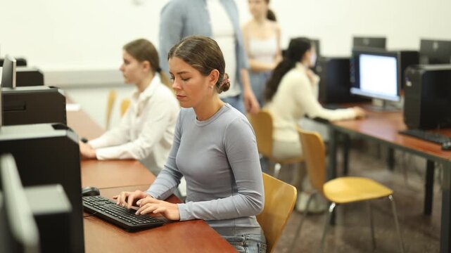 Portrait of young female student studying in university computer class