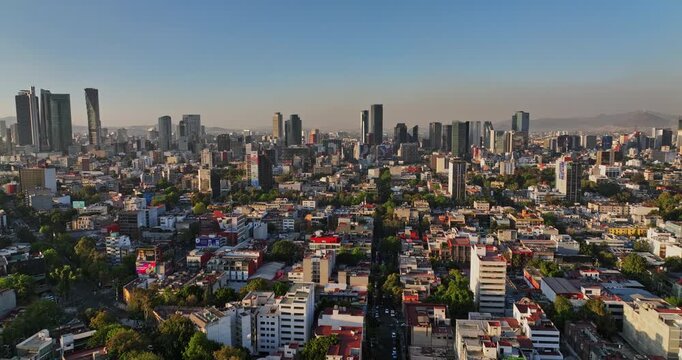 Mexico City Aerial v14 establishing shot drone flyover roma norte capturing artistic neighborhood with downtown cityscape along the skyline at sunset - Shot with Mavic 3 Cine - December 2021