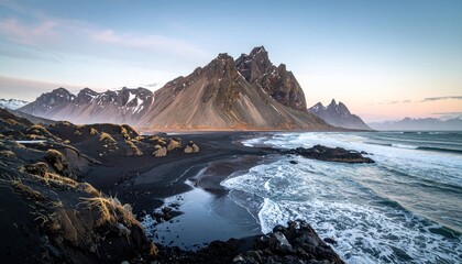 Fototapeta premium Dramatic Black Sand Beach with Jagged Mountains and Ocean Waves at Sunset