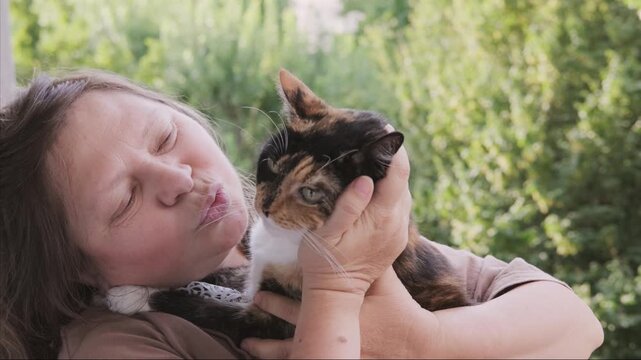 plus size woman holding calico cat, tortoiseshell feline, hugging pet and care, Human animal bonding friendship, furry friend, animal lover, casual clothing, domestic kitten, warmth and trust