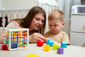Fotobehang Lego Toddler sorting colorful cubes. Logic development through play. Colorful educational toy supports natural curiosity and brain development  © Krievietka