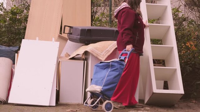 woman browsing old items bulky waste collection point, Second life old items versus consumerism, pile discarded furniture, reuse and recycling, sustainable living, mindful consumption, waste reduction