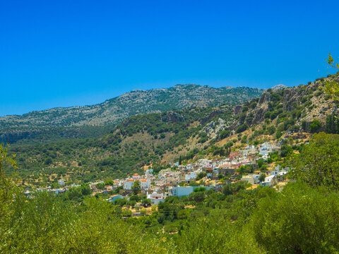 Traditional hillside village of Kritsa surrounded by mountains (Crete, Greece)
