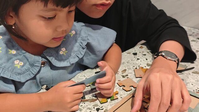 Mother Playing Puzzle Game with Little Child at Home