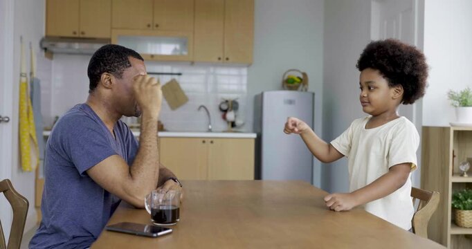 Playful African black father little boy father young son playing rock paper scissors spending quality family time together at home. Hobby free time, leisure time activity