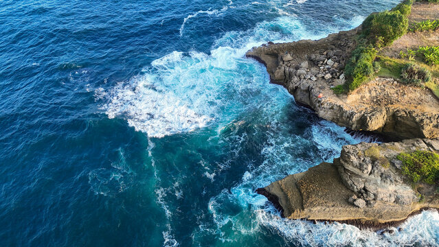 Aerial View of a Dramatic Rocky Coastline and Crashing Ocean Waves at Hidden Gems Beach, Tulungagung Regency-East Java