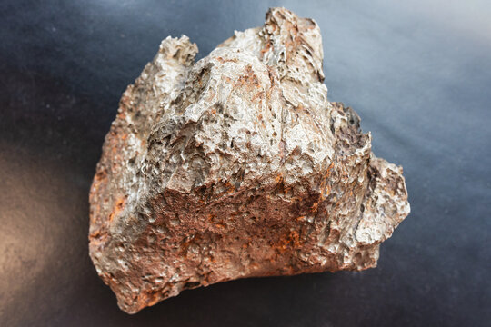 rusty raw meteorite close-up on black