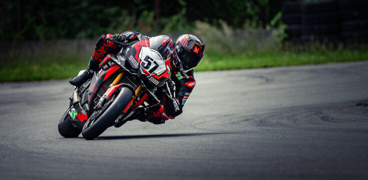 Regular training in Riga, Latvia, Bikernieki on 12-05-2026  Motorcyclist leaning into a turn on road