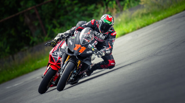 Regular training in Riga, Latvia, Bikernieki on 12-05-2026  Two Motorcyclists Racing on a Curved Road