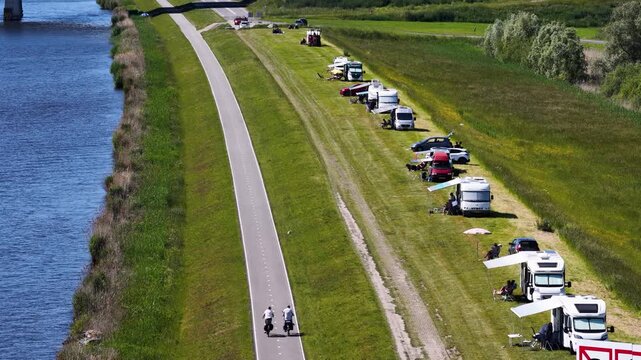 oadside tourism with campers on a dike with cyclists, Netherlands