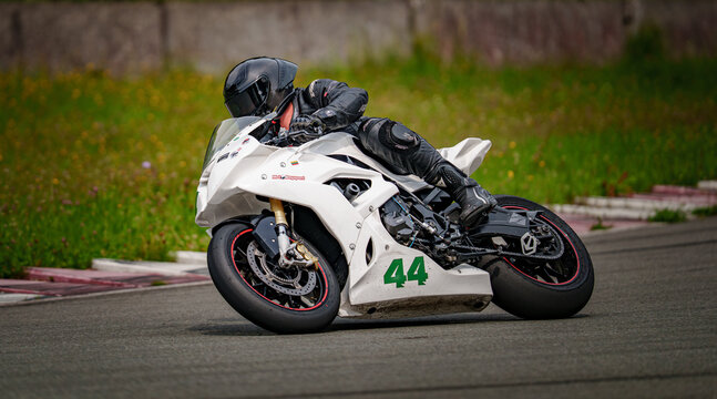Regular training in Riga, Latvia, Bikernieki on 12-05-2026  Motorcycle racer leaning into a turn on a racetrack
