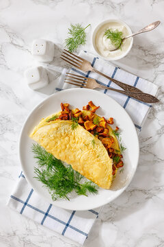 Egg omelet with fried wild chanterelles and dill