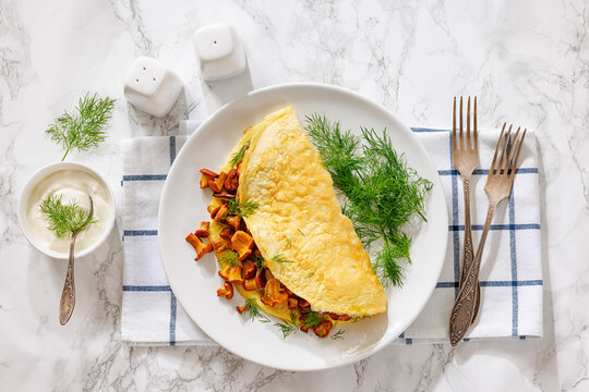 Egg omelet with fried wild chanterelles and dill