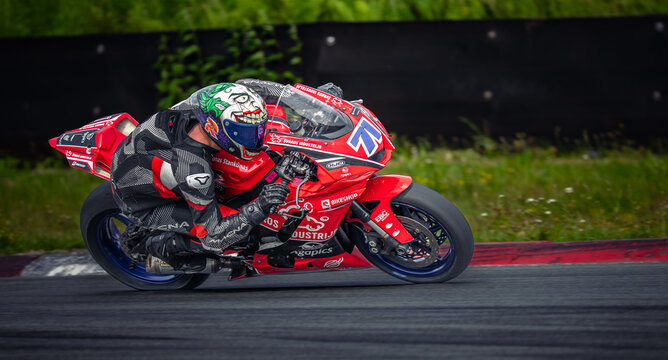 Regular training in Riga, Latvia, Bikernieki on 12-05-2026  Motorcyclist racing on a track with green helmet