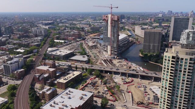 Ballys Casino building under construction by Chicago River in River North near Chicago Avenue Station and expressway overpass in Illinois with railway and city traffic