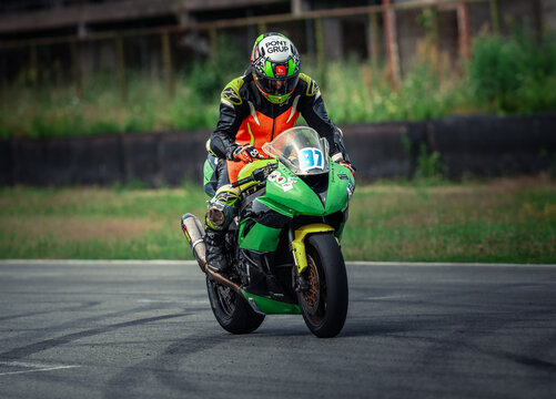 Regular training in Riga, Latvia, Bikernieki on 12-05-2026  Motorcyclist racing on a track in green gear