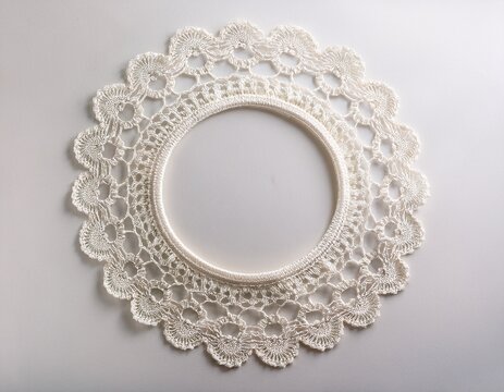 white lace doily with a circular frame on a white background