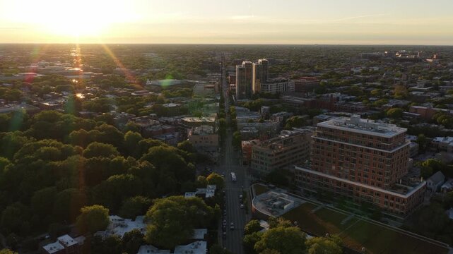 Golden hour sun flare illuminating Chicago's Hyde Park neighborhood, vibrant cityscape with lush trees, residential buildings, bustling city streets