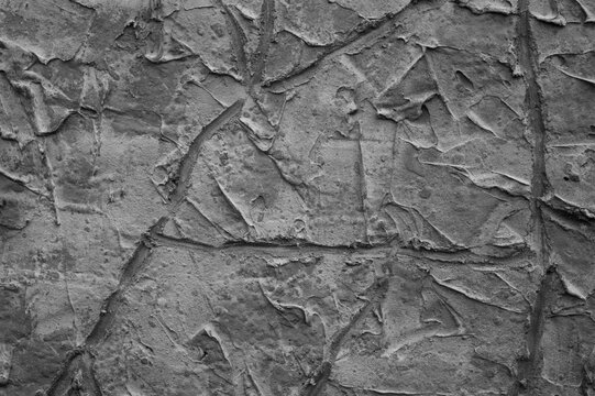 gray background, in the photo the texture of a gray wall with various lines, strokes and cracks
