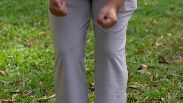 Body Language and Nature's Embrace: An anonymous person demonstrates a unique physical gesture within a vibrant outdoor setting, where the fresh and natural environment creates a soothing ambiance.