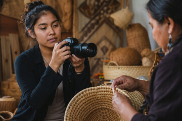 Left handed indigenous youth photographer documenting crafts