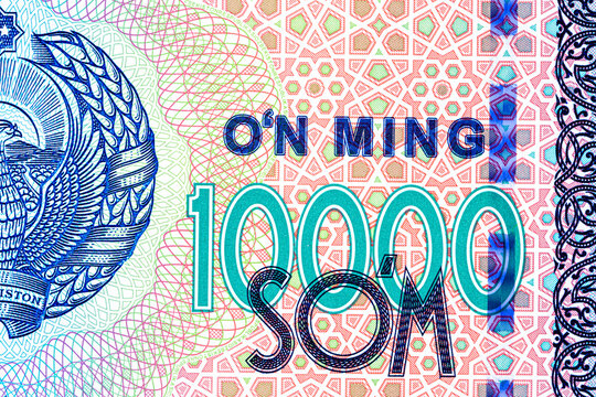 A 2017 banknote of 10000 Uzbek soums. The obverse depicts the state emblem. The reverse side of the banknote features an image of the Senate building in Tashkent.