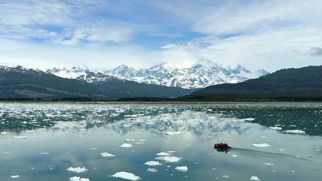 Exploring icebergs in a zodiak boat on a chilly day in the Arctic region near glacier areas
