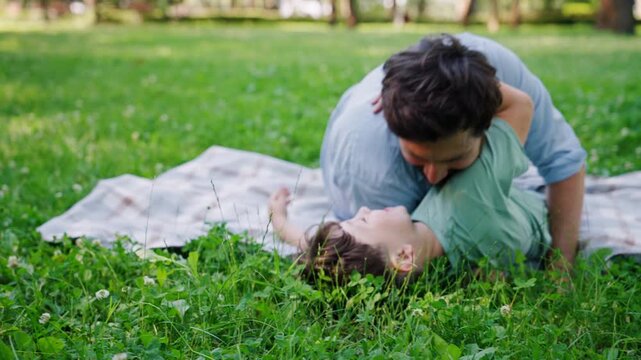 Caring father happily catches laughing child during exciting game