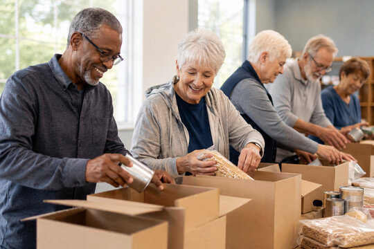 Senior Volunteers Packing Boxes in Community Center