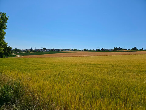 germany, magnificent panoramic countryside of colorful fields overlooking ostfildern kemnat skyline with cranes beneath vivid summer blue sky