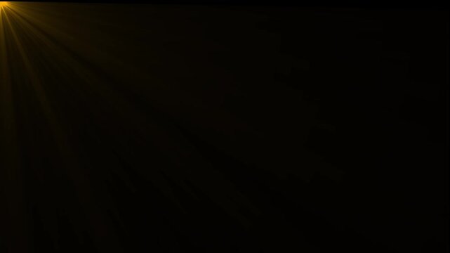 Golden yellow light flare emanating from the left corner casting soft diagonal rays across a solid black background for a warm effect