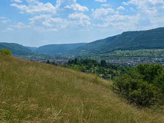Fototapeta premium germany, wide panoramic landscape above dettingen an der erms showcasing rolling green valleys and picturesque swabian alb countryside in summer