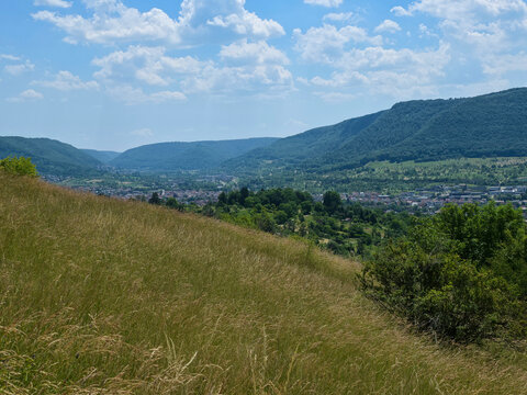 germany, wide panoramic landscape above dettingen an der erms showcasing rolling green valleys and picturesque swabian alb countryside in summer