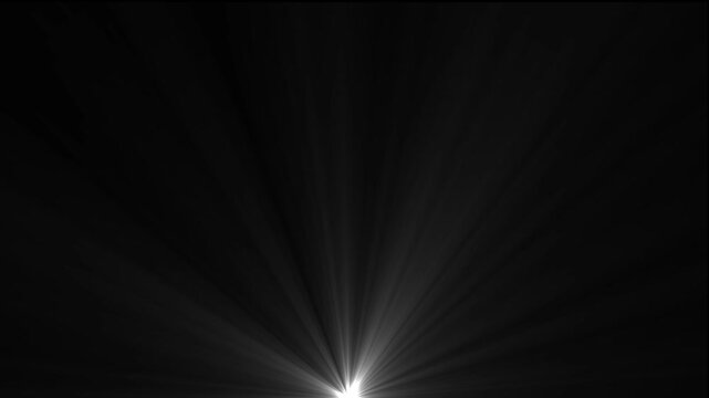 Bright white light flare bursting from the bottom center with soft rays of light spreading upwards against a solid black background surface
