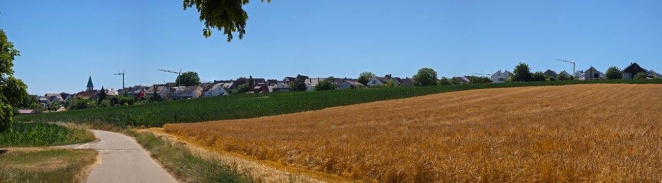 germany, breathtaking panoramic countryside road approaching ostfildern kemnat with village homes framed by colorful summer agricultural fields